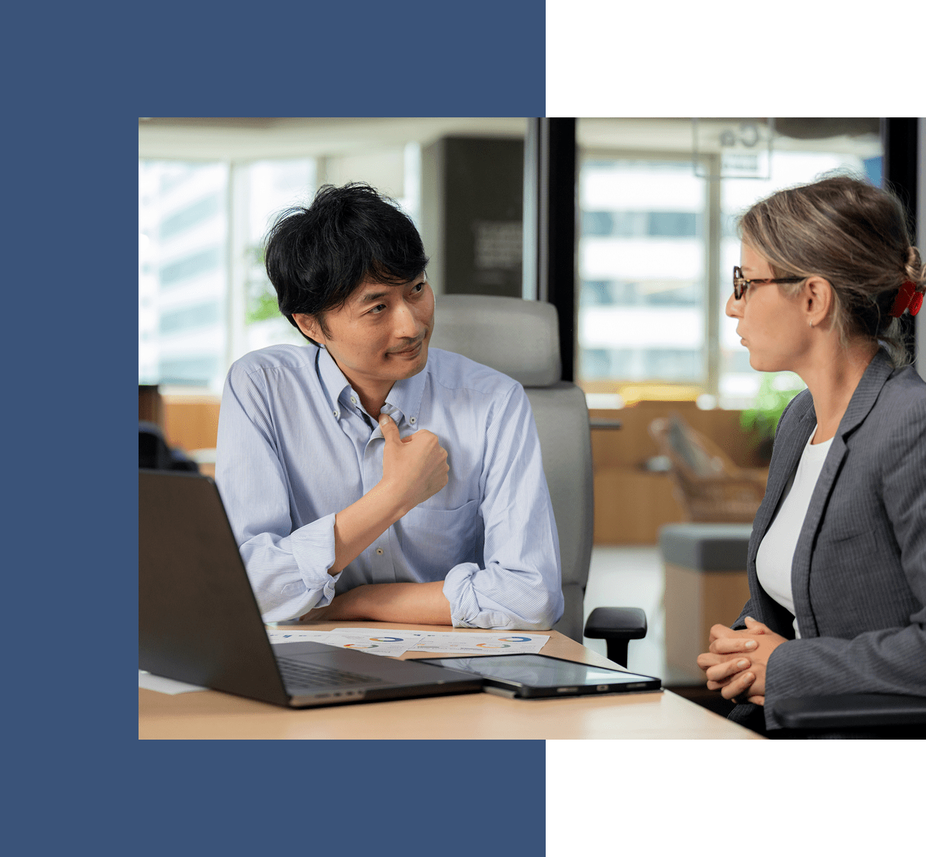 Two colleagues discussing in an office.