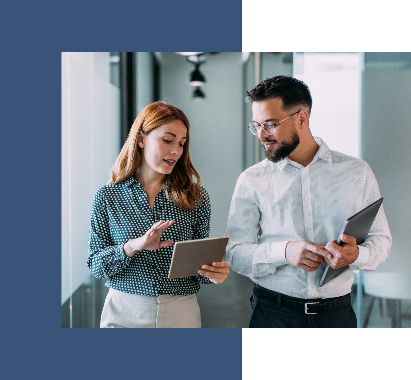 Two colleagues discussing work on tablet.